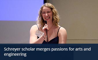 person smiles while standing at a podium