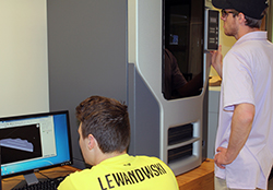 Mike Frost and Sean Woodrow get ready to print the prototype of their toothpaste squeezer on the Stratasys Fortus 250mc 3D printer.