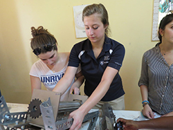 Kelly Hensler (left) and Heather Svec assemble the baobab processing machine.